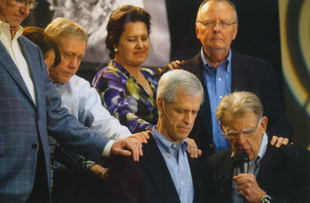 Kurt Nelson is prayed over by John Maisel and the board when he became CEO