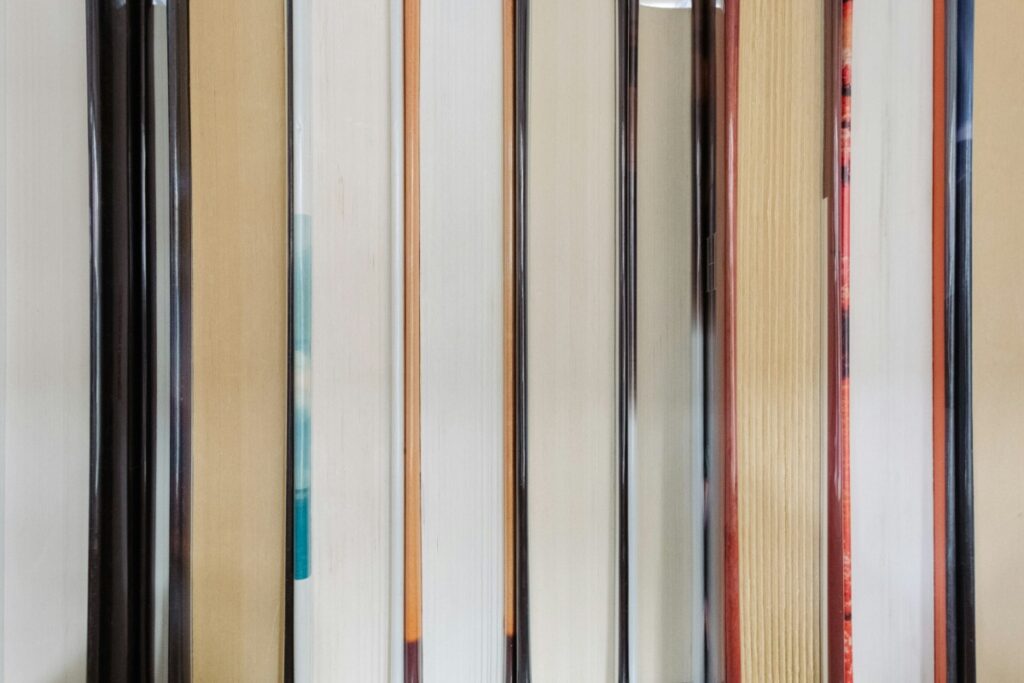 Close-up of the edges of vertically aligned books on a shelf.