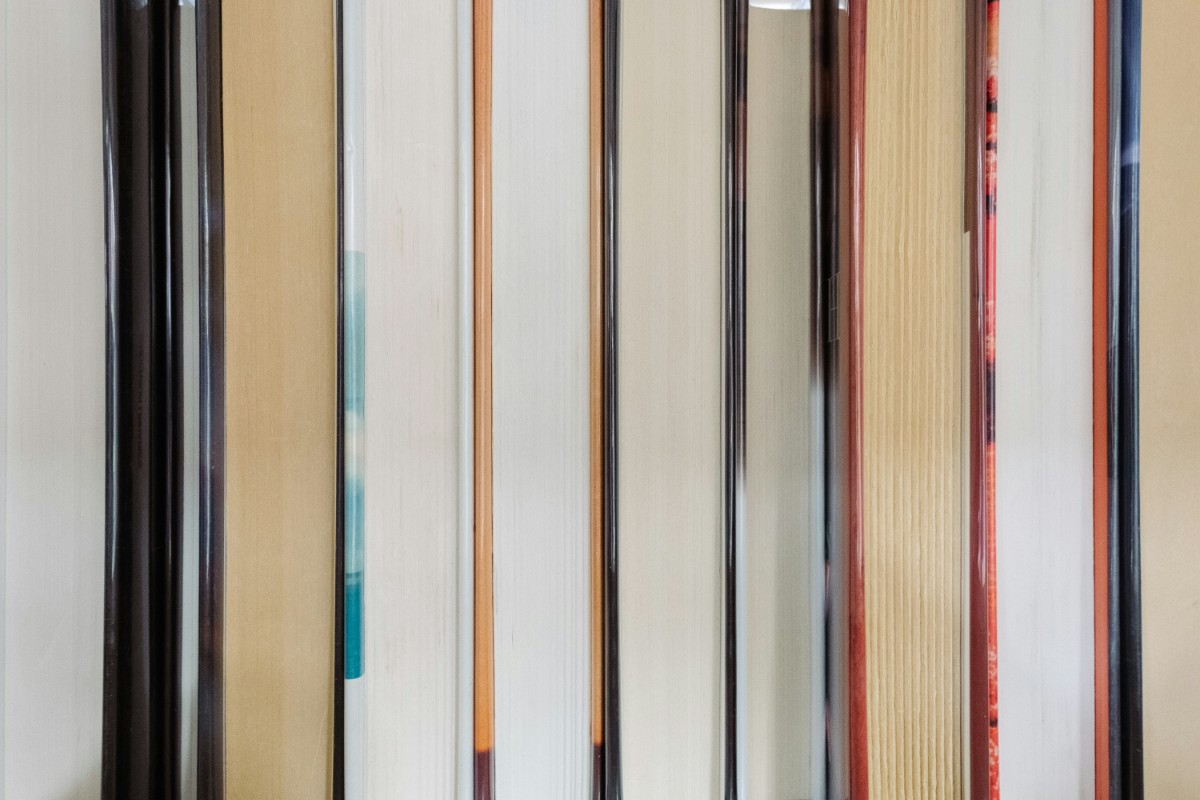 Close-up of the edges of vertically aligned books on a shelf.