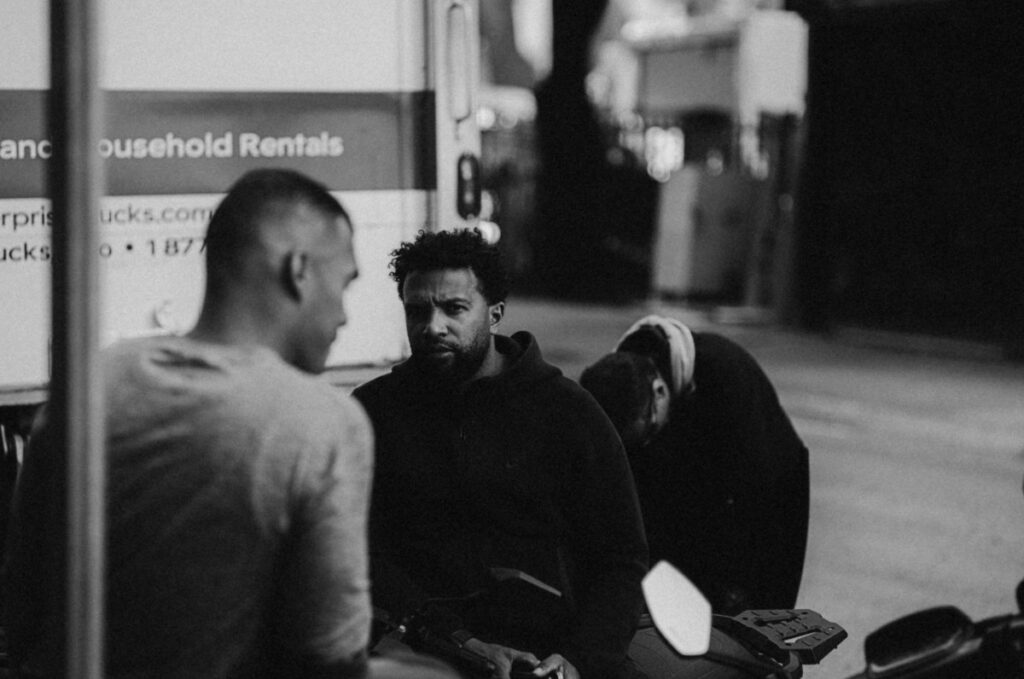 Black and white photo of people walking in the street.