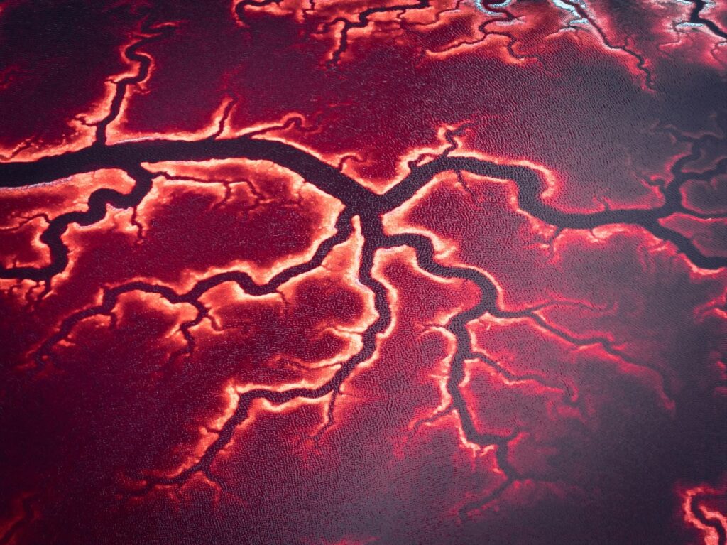 Close-up of vibrant red and black marbled pattern resembling lava cracks or veins, with glowing edges on a smooth surface.