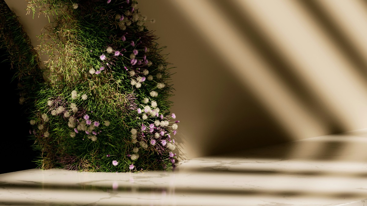 A wall decorated with green foliage and small purple and white flowers, illuminated by sunlight casting parallel shadows on the surface.