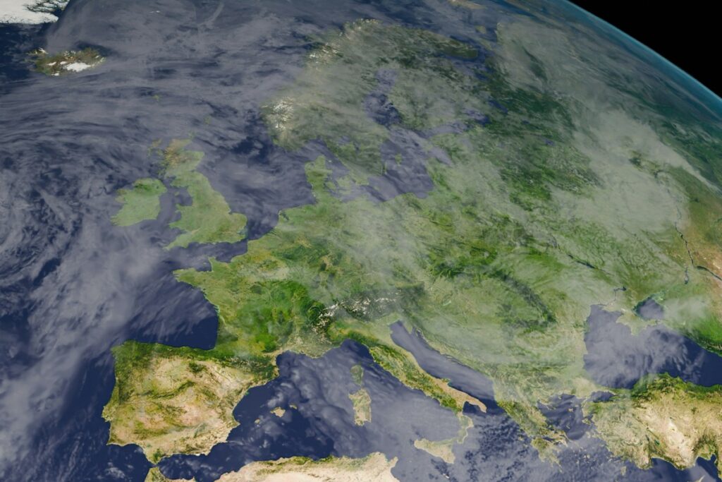 Satellite view of Europe from space, showing various countries with visible land features and cloud coverage.