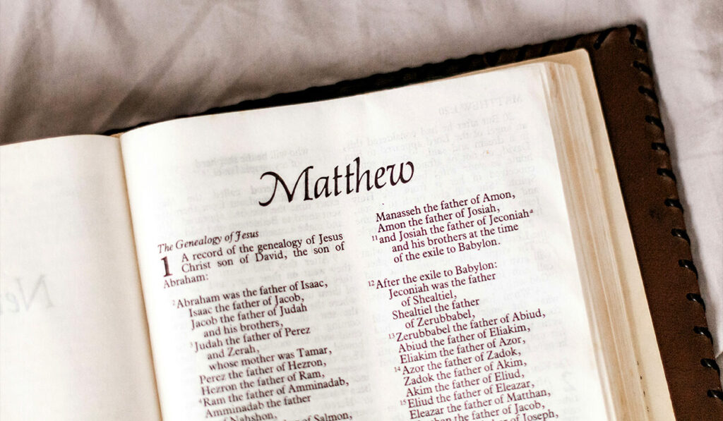 A Bible is opened to the book of Matthew, in which the genealogy of Jesus is listed.