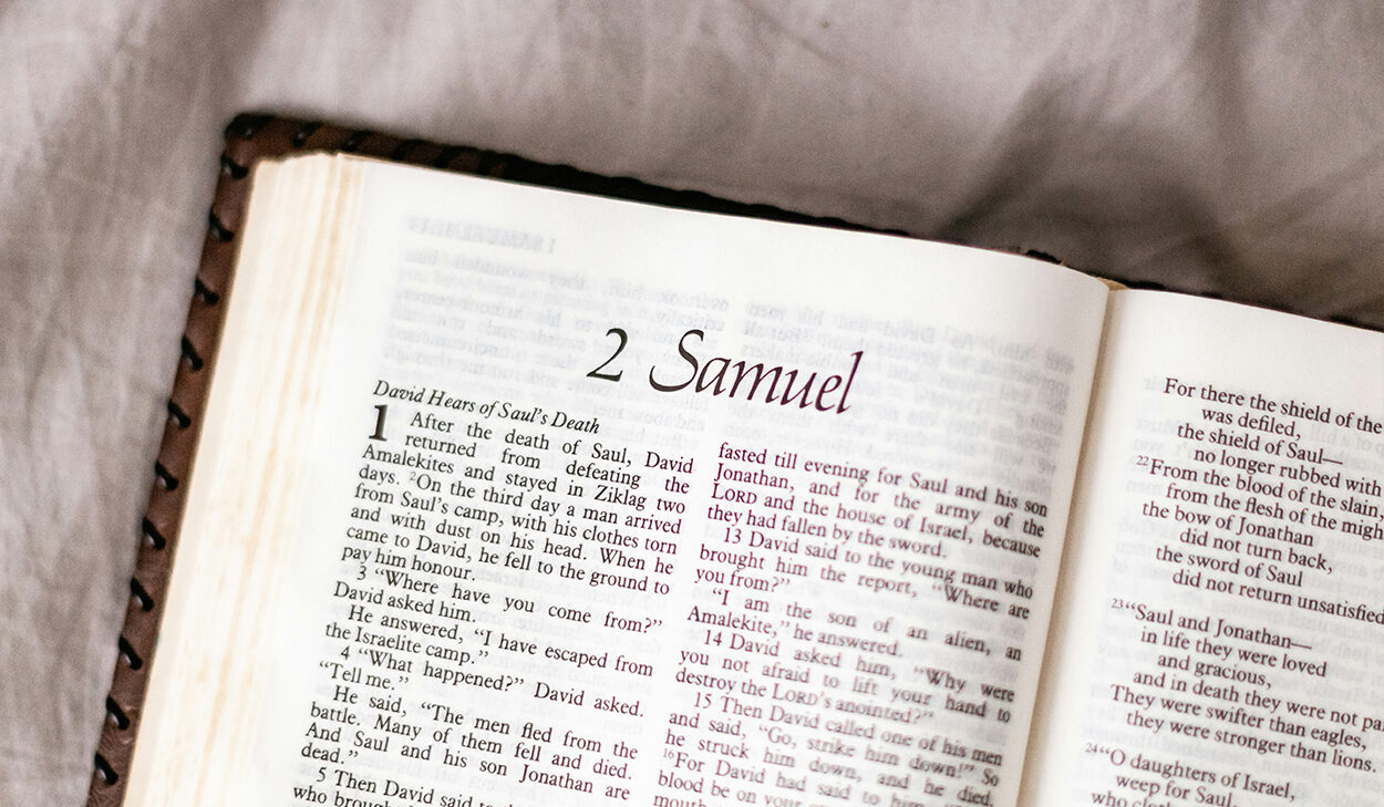 A brown leather Bible is open to the book of 2 Samuel.