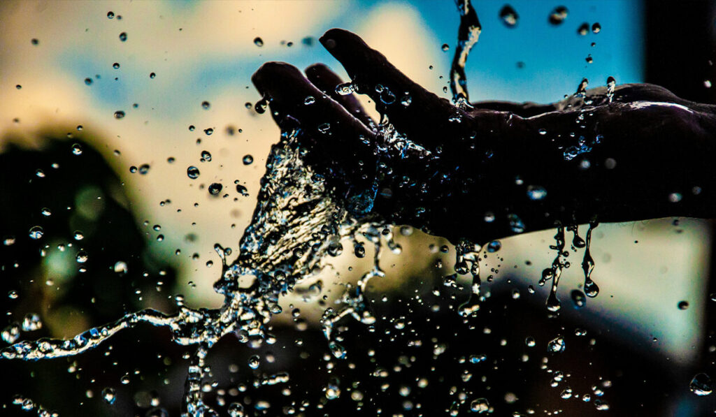 A hand cups water.