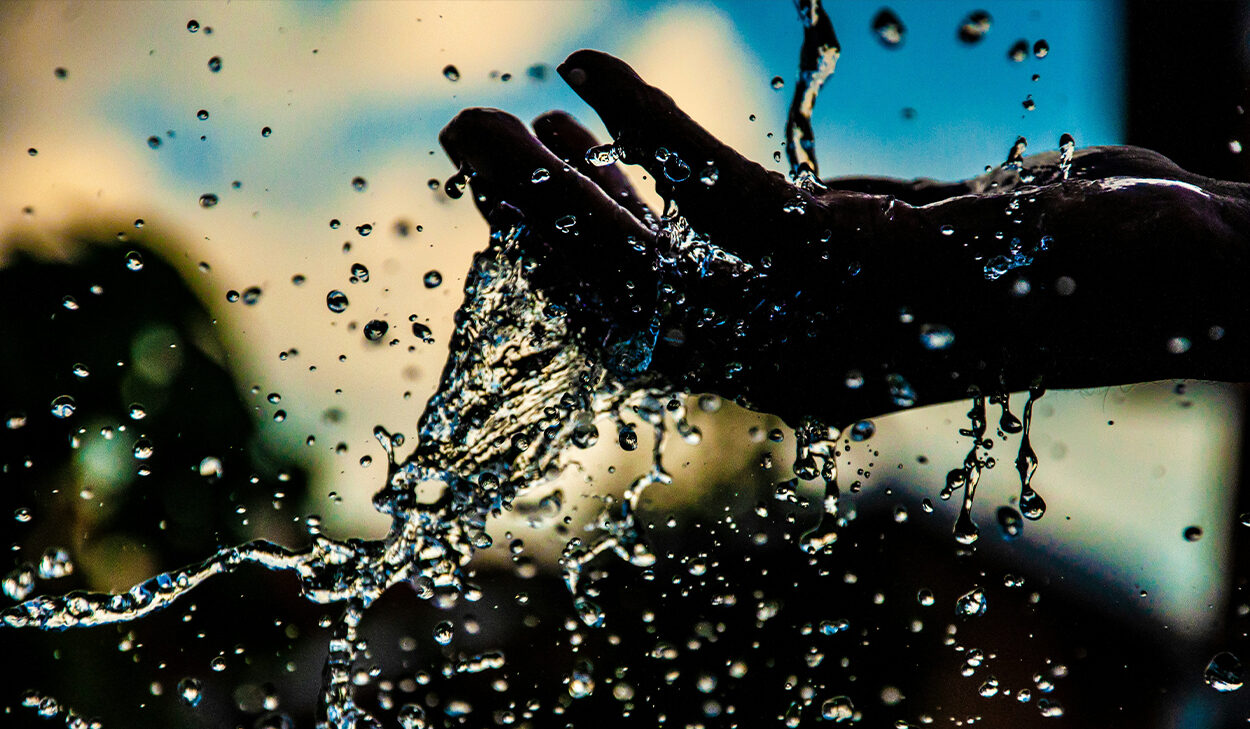 A hand cups water.