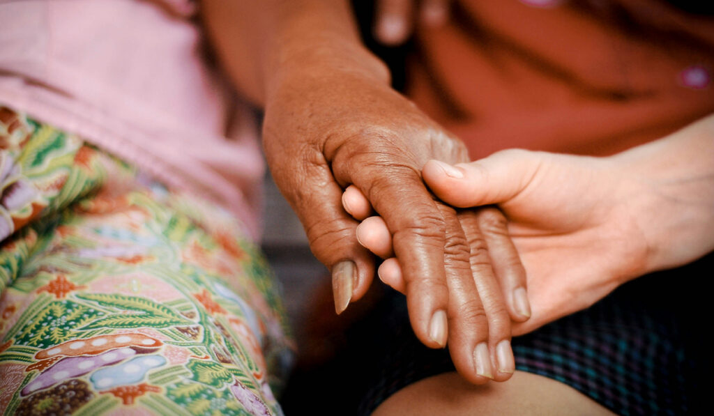 Two people holding hands