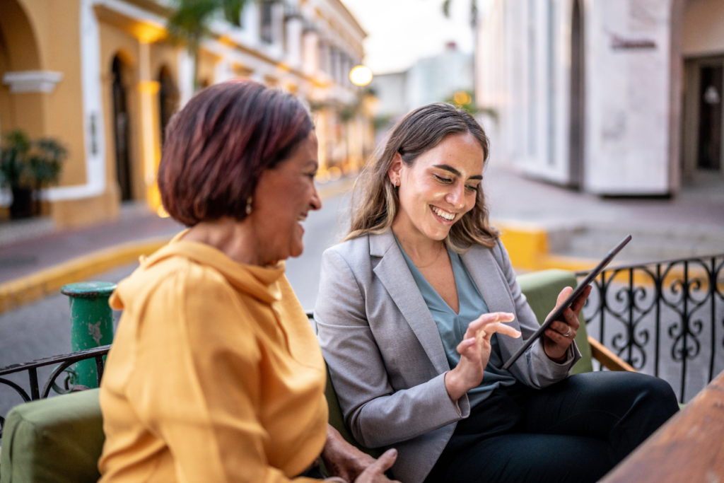 Two women enjoying a conversation outdoors.