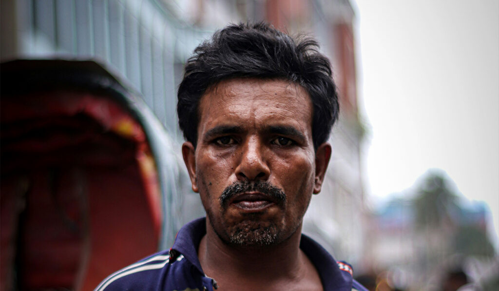 A man stands in the middle of a street.